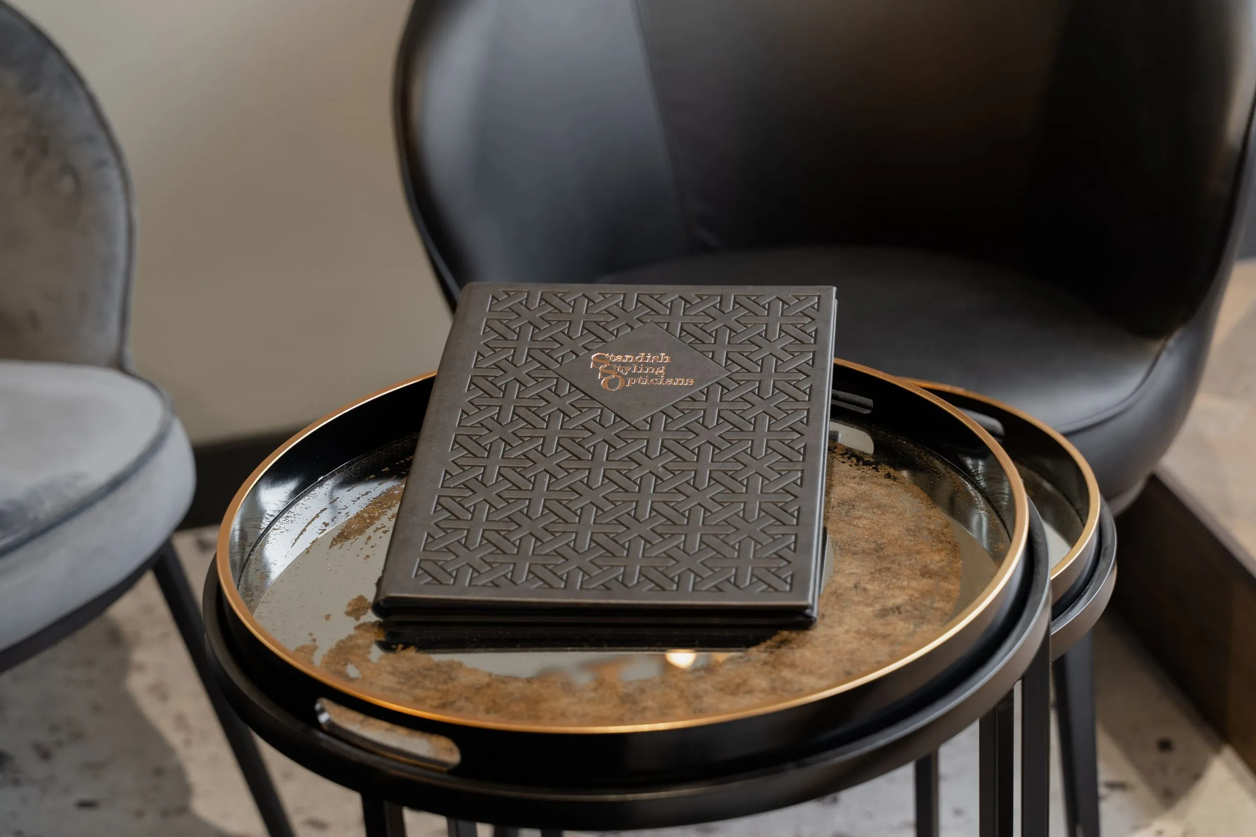 The practice's embossed drinks menu on a gold-rimmed tray